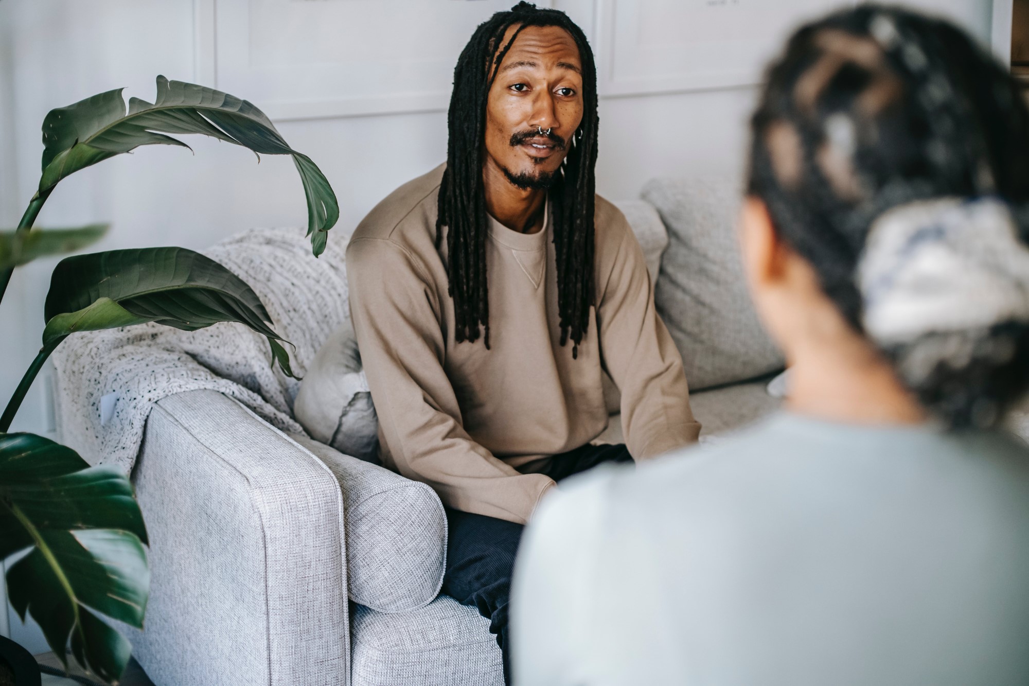 PLACEHOLDER IMAGE — A support worker sitting with an older man, offering a friendly listening ear